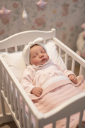 Baby girl in a small cot