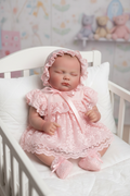 Bella sat up in cot