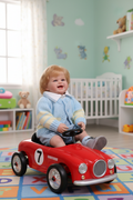 Reborn boy doll in toy racing car