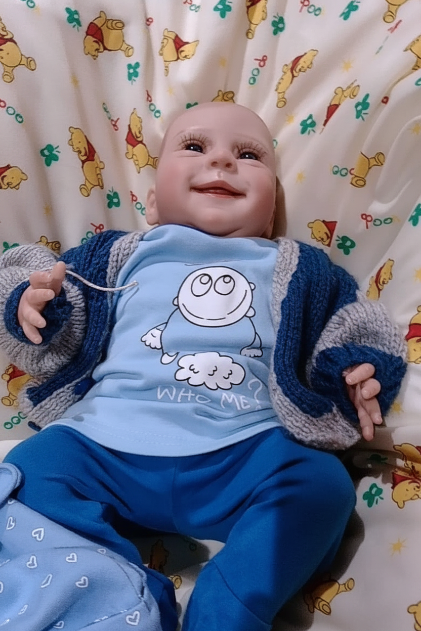 Reborn doll on cushions no label
