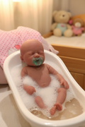 Reborn newborn doll in baby bath